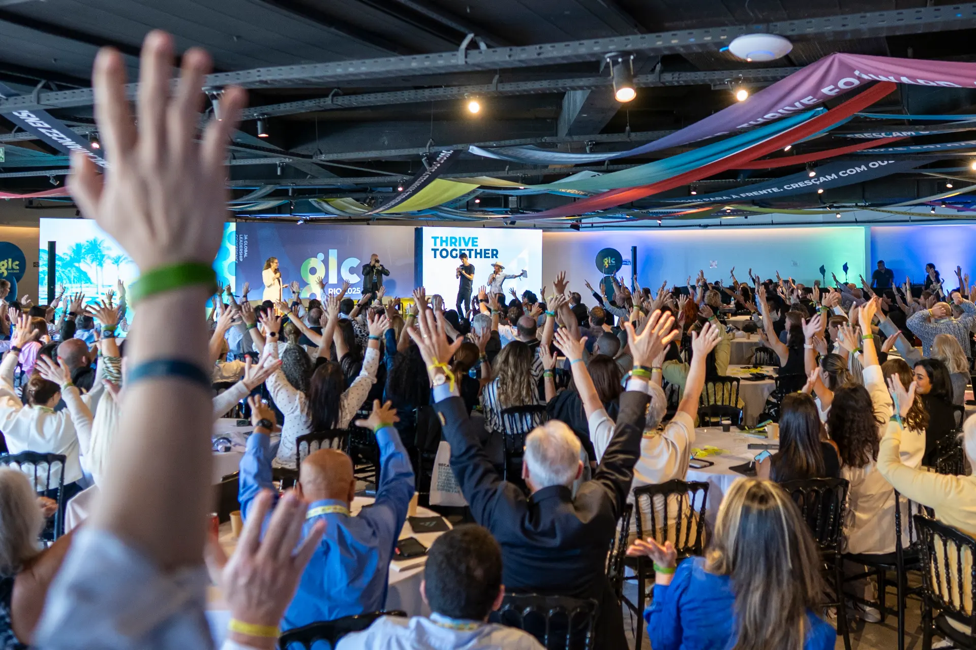 Audience with raised hands at the JA Global Leadership Conference Rio 2025