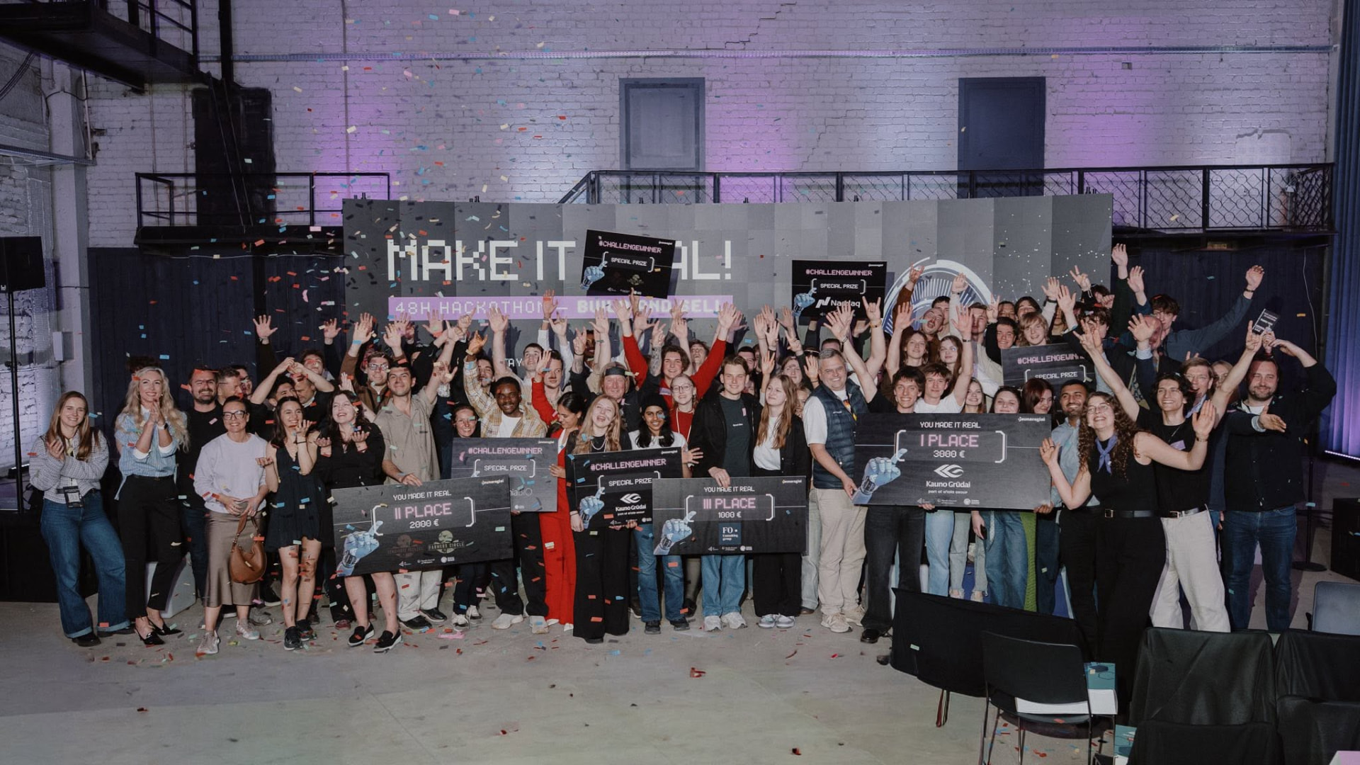 Hackathon winners celebrating with prize boards and confetti