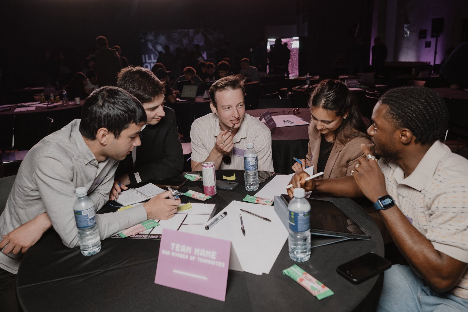 A team collaborating around a table during a 48-hour hackathon