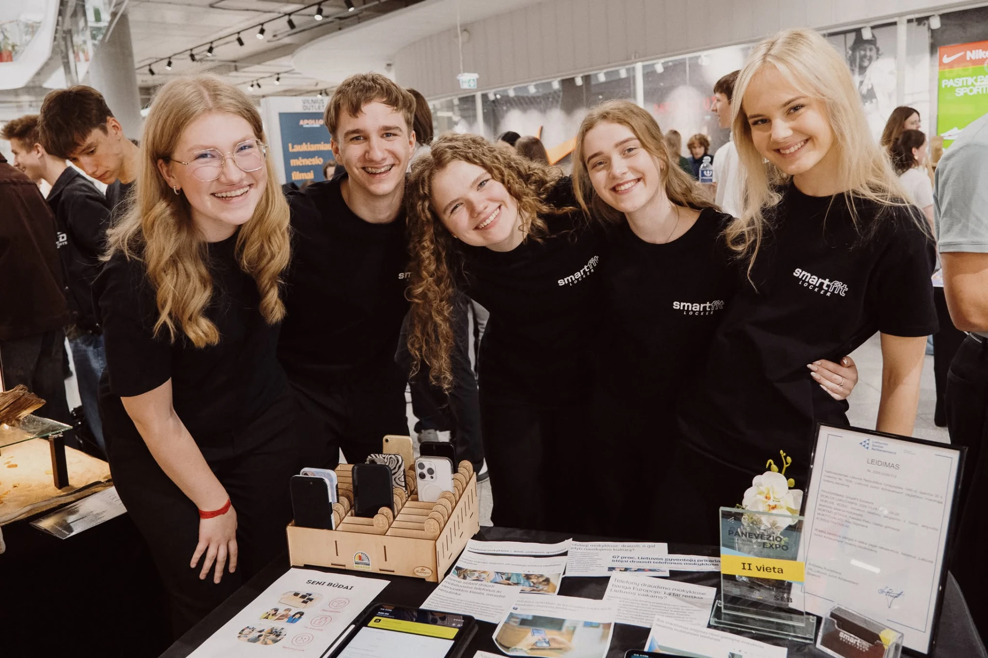 Student company team presenting their product at an expo booth